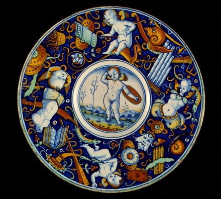 Plate with border of putti and trophies amid grotesques; in the center, a winged putto standing, armed, in a landscape