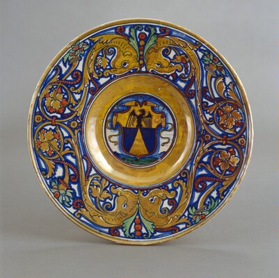 Plate with border of foliate scrollwork with dolphin heads and cornucopias; in the center, shield of arms of Vigerio of Savona