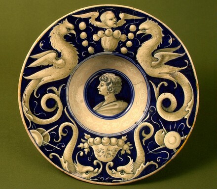 Broad-rimmed bowl with border of dolphins and "delphigriffs"; in the center, head of a young man