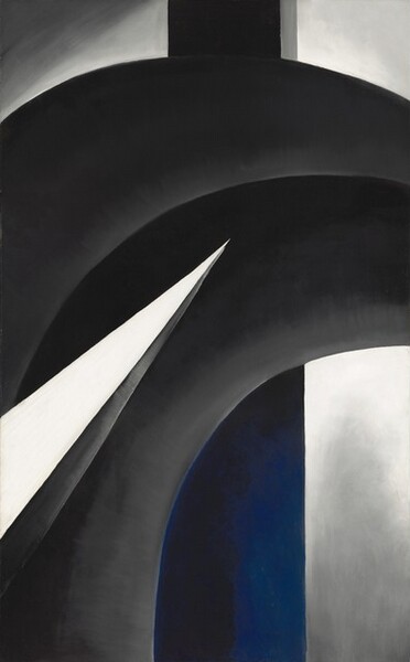 This vertical, abstract painting is made up of overlapping, intersecting geometric forms in shades of gray, cobalt blue, white, and black. The largest form is made up of a pair of black bands, running side by side, that extend up from the lower left corner to curve to the right off the edge of the composition beneath the upper right corner. The bands are shaded with pale gray along the bottom edges. In front of that curving black form, a vivid white, narrow triangle like a blade cuts into the composition from near the lower left corner, and it stretches halfway across the painting at an upward angle. The bottom edge of the triangle is painted nickel gray, suggesting that it has another facet in a three-dimensional form. A vertical shaft running behind the curving form is black at the top and cobalt blue where it is nestled under the curving form. The background lightens from steel gray at the corners to brighter white near the center.