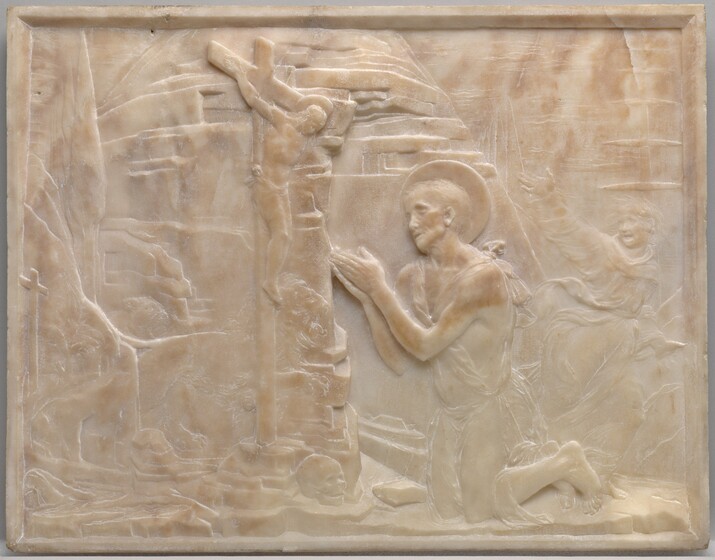 A man wearing a cloak tied around his body kneels with his hands together at the foot of a crucifix, set against a rocky outcropping on this stone panel. The scene is shallowly carved in low relief from pale, apricot-peach marble. Both the kneeling man, Saint Jerome, and the man hanging on the cross have raised, disk-like halos. Slightly right of center, the kneeling man looks up at the cross from under heavy brows. He has hollow cheekbones and short hair. His robe is tied over his shoulders and falls across his hips, but his feet and slender arms are bare. The man on the cross is smaller in scale, less than half the size of Saint Jerome. He hangs heavily from his hands, which are nailed into the cross, and his head falls forward. He is nude except for a loincloth across his hips. A rocky, hut-like form fills the space behind Saint Jerome. A few details are lightly carved so are visible only on closer inspection. These include a smaller cross along the left edge of the panel and a skull at the base of the crucifix. Between the crucifix and rocky structure, a male and female lion run toward Saint Jerome, mouths open. In the space between Saint Jerome and the right edge of the panel, another person is lightly carved into the background. He runs to our right while looking back over one shoulder, perhaps at the lions. One hand is flung high, his mouth wide open, and his hair stands on end. His voluminous robe flutters around his body. Beyond him, triangular trees recede into the distance under a cloud-streaked sky.