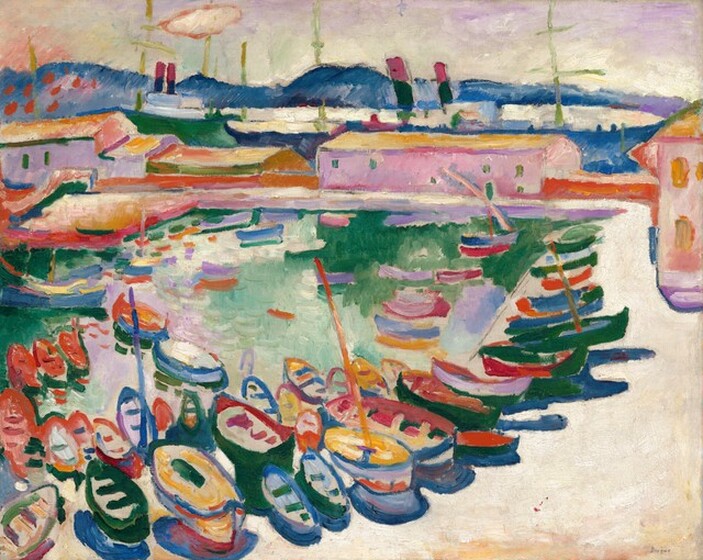 We look across a sandy colored beach or walkway that stretches away from us to our right and then turns ninety degrees to our left in the distance, to enclose a teal-colored body of water filled with rows of small rowboats in this nearly square, stylized landscape painting. The scene is loosely painted with vibrant colors, in jewel-toned topaz and royal blues, emerald and mint greens, pale orchid purple, golden yellow, cream-white, and crimson red. The boats grouped along the beach close to us are lined up in a row along the beach to our right, punctuated by a few vertical masts. The beach across from us in the distance is lined with a cotton candy-pink, pale lavender purple, sage green, and pumpkin-orange warehouses in front of a line of cobalt-blue mountains along the horizon, which comes nearly to the top edge of the canvas. The sky is pastel purple, green, yellow, and peach above. The artist signed the work in dark paint in the lower right corner: “Braque.”