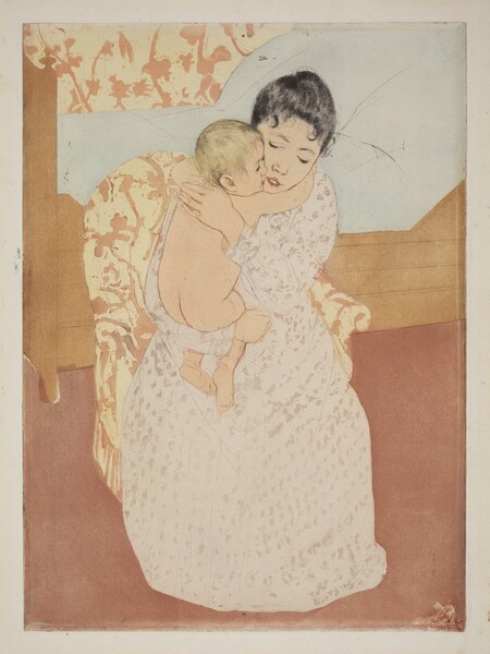 We look slightly down onto a young woman sitting in an upholstered chair and tightly hugging a nude, blond child in this vertical, colored print. Both have pale, peach-toned skin. The woman’s black hair is pulled back though a couple tendrils curl on her forehead. Her eyes are downcast and her pink lips parted. She wears a long, cream-white dress dotted with blush-pink, petal-like forms. One arm is under the baby’s chubby bottom and the other braces the child behind the shoulders. The baby wraps their arms around the woman’s neck so they are cheek to cheek. The chair sits in front of a bed with a boxy frame and a pillowy pale blue mattress. The upholstery on the woman’s chair and the wallpaper behind her are patterned with dusky rose-pink flowers and vines against very pale yellow. The floor is also dark rose pink.