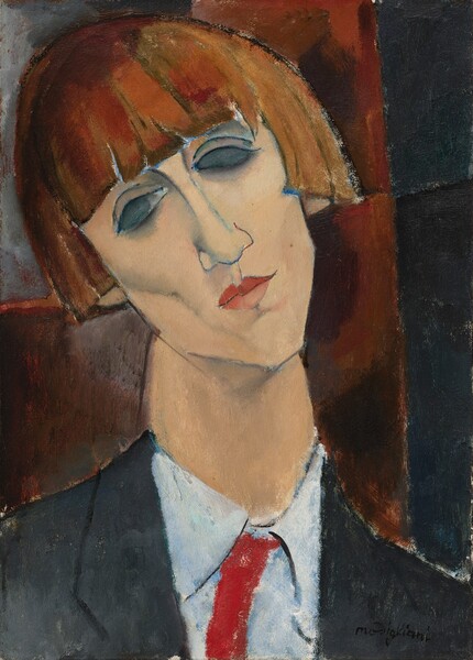 This vertical portrait painting shows the head and shoulders of a person with pale peach skin and an auburn, cheek-length bob hairstyle. The person has high cheek bones, deep pink lips, and an angular, pointed chin. The head is cocked to our left, and almond-shaped eyes are nearly blacked out. The black jacket has lapels over a white, collared, buttoned-up shirt with a crimson-red necktie. Shown against brick-red and black background, the portrait is painted with areas of relatively flat color but with loose brushstrokes that create a textured, mottled effect. The artist signed the work with black paint in the lower right corner: “modigliani.” 
