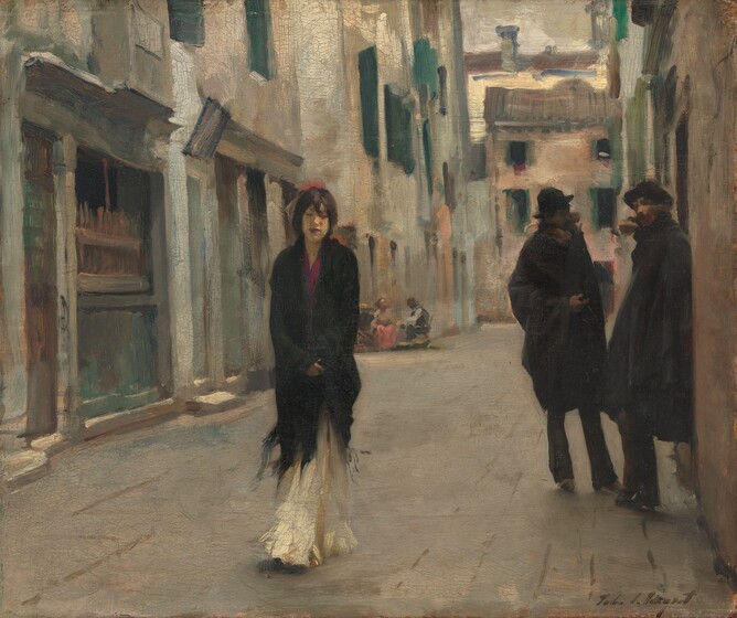 A thin, narrow-shouldered woman holding a black shawl close to her body walks towards us down an alleyway past a pair of men wearing all black in this horizontal painting. One of the men’s faces is in shadow but all three people seem to have light skin. The woman’s shawl wraps around her shoulders and the bottom hem, edged with fringe, kicks around her shins over a long, cream-white skirt. A stroke of magenta-pink at her neck, perhaps her shirt, is echoed in the deep pink of her closed, full lips. Her gaze seems to be downcast and her features, like much of the rest of the scene, is loosely painted. A touch of coral-red on her head could be a flower or decoration in her chestnut-brown hair, which seems to be pulled back. Behind her and to our right, two men stand, presumably talking, near a building. Both wear black hats and the collars of their black coats seem to be lined with fur. One man leans against the building and looks towards the woman. The other man looks at his companion, his face lost in shadow. In the distance, a man and woman sit at a small table on the opposite side of the alley. Buildings rising along the walkway to our left and right fill the composition and extend off the top edge. At least two buildings close off our view across the far end of the alley. A higher structure behind one of them seems to catch sunlight with a touch of bright, cream-white, but the scene in the alley is softly lit, in diffused shadow. The faces of all the buildings are ivory or pale peach, and most have forest green shutters. On the buildings, the paint is applied in rough layers to mimic stucco or plaster. Throughout the work, loose brushstrokes are visible. The artist signed the work in dark paint in the lower right corner: “John S. Sargent.”