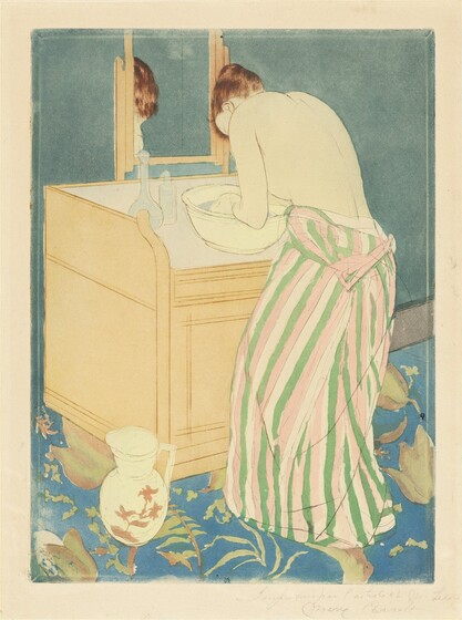 A pale-skinned woman bends over a basin of water on a washstand in this vertical, colored print. The woman is angled away from us so only her ear and the curve of her forehead are visible beyond her hunched shoulder. Her upper body is bare, her dress having been unfastened so it hangs around her waist. The dress is striped with grass green, rose pink, and the cream white of the paper. Light gleams on her auburn hair, which is tied up and back. She cups her hands in the light blue water of the faintly yellow basin. Two bottles sit at the back corner of the washstand, and a mirror reflects the top of her head. The fawn-brown washstand is boxy, and a handled white pitcher painted with muted pink flowers is at the front left corner, which is closest to us. The wall beyond the washstand is marine blue, and the floor is brighter sapphire blue with a pattern of celery-green leaves. A mark with an oval, or a mirrored C, over an uppercase M, is stamped in royal blue at the bottom center of the print. The sheet is inscribed with graphite across the right half of the bottom margin, “Imprimée par l'artiste et M. Leroy Mary Cassatt.”