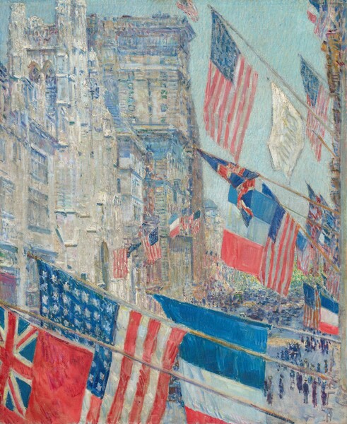 We look beyond a cluster of flags hanging from the side of one tall building onto a wide street at a row of buildings across from us in this vertical painting. The scene is loosely painted with visible brushstrokes, so some details are difficult to make out. We seem to lean out a window to look along the street, so the building to our right only skims the edge of the composition and continues off the top. The three flags closest to us fly from nearly horizontal flagstaffs along the bottom edge of the painting. All the flags are in shades of scarlet red, white, and royal blue. The flag closest to us is red with the red, white, and blue Union Jack in the upper corner. Beyond it is an American flag with 49 stars, and then the French flag with the vertical bands of blue, white, and red. Those three flags are repeated about a dozen times along the building that stretches away from us, along the right edge of the painting. More of those flags are hung from the cream-white and tan buildings across the street, to our left. Some of those buildings reach off the top edge of the canvas and others come close. The shadows along moldings and the windows are painted with pale and lapis blue. Through narrow gaps left between the fluttering flags, vertical strokes of navy blue and violet purple suggest crowds of people in the street below. The sky between the buildings is ice blue. The artist signed and dated the painting in the center left, “Childe Hassam May 17 1917.”