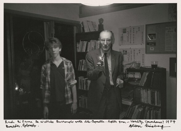 Rudi DiPrima & William Burroughs with his cigarette lighter gun -- Varsity Townhouse? 1984 Boulder, Colorado.