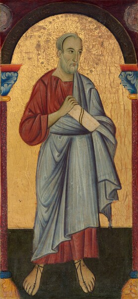 A man with light skin with a greenish cast, wearing a slate-blue robe draped over a burgundy-red, ankle-length tunic, stands under an arched opening against a glimmering gold background in this vertical painting. The man’s body faces us but he turns his head to our right and looks off in that direction with dark eyes under curving, dark brows. Like his skin, his white hair and beard has a greenish cast, but is painted with long, curving white lines to indicate the flow of hair. He has a high forehead, a long, thin nose, and his small pink lips are closed. His left arm, on our right, is wrapped in or hidden by his robe, and he holds a parchment-colored scroll in front of his chest with his other hand. His clothing is painted with lines to indicate folds. He wears sandals with thin, mahogany-brown straps on his feet and stands on a pine-green floor. His head is surrounded by a halo created by incising and punching the gold background behind the man. The shoulder-wide halo is decorated with S-shaped spirals and a ring of simple, delicate flowers around the perimeter. The arch above the man is supported by maroon-red columns topped by cobalt-blue, leafy capitals. The corners above the arch are maroon red, and rough, disk-shaped areas in each corner could indicate losses. A web of cracks stretches across the gold areas. Writing along the arch reads, “SANCTVS I HANES SSUM.”