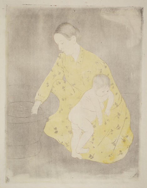 A woman kneels to test the water in a freestanding bathtub with one hand as she braces a nude child against her knee with the other in this vertical, colored print. The people and objects are outlined lightly with black, and both the woman and baby’s hair are incised with delicate black lines. The woman and baby’s skin are the white of the paper, and the rest of the background is smudged with smoke gray to show the texture of the paper. The woman’s hair is pulled back from a high forehead, and she has a straight nose, pursed lips, and a slight double chin. Her long-sleeved, floor-length dress has a narrow collar and is pleated across the chest and at the cuff we can see. The dress is filled in with a field of butter yellow and patterned with a floral design. The baby turns toward the woman’s body and hangs their arms over her bracing hand. The baby has short, wispy, black hair with delicate facial features, a rotund belly, and satisfyingly pudgy rolls on the legs.