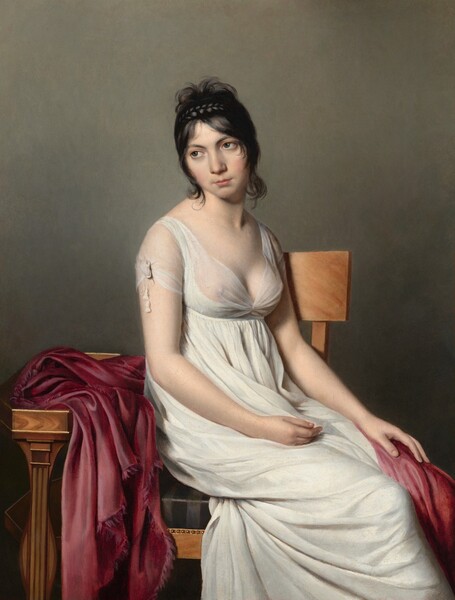 A pale-skinned woman wearing a filmy white gown sits sideways on a wooden chair in front of a slate-gray wall in this vertical portrait painting. With her body angled to our right, her shins are cut off by the bottom corner of the painting, and she gazes back over her other shoulder, to our left. Her head is tipped toward that shoulder, and she looks into the distance with charcoal-gray eyes below dark brows. Her cheeks are flushed and her small, peach lips are closed. Her black hair is braided in a single horizontal plait above wispy fringe that frames her face and curls down the back of her neck. The low-cut neckline of her ivory-white dress is sheer across her chest, revealing her breasts. The fabric is gathered under a thin band just under her bust, and it drapes down from there. The short sleeve we can see, on her right arm, is tied with two tassels hanging from either end of a string. Her hands rest in her lap, with her left hand, farther from us, on a silky, radish-red cloth that drapes over that knee and around her back. The rest of the cloth is piled on a narrow wooden table edged with gold at the small of her back. The chair on which she sits has a simple wooden panel as the back rest, and the seat is upholstered in fabric with shiny and matte black stripes. Tiny gold bosses line the edge of the chair near the cushion. The background behind her gradually darkens from slate gray at the top of the canvas to a dark charcoal near her legs.