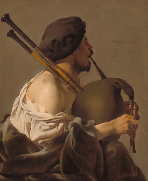 Shown from the lap up, a man with pale skin sits facing our right in profile, playing a bagpipe in this vertical painting. He is lit from our left so his face is in shadow, and he looks off to our right. He has dark eyebrows, a chestnut-brown mustache and short beard, and a rounded nose. He wears a floppy, chocolate-brown beret that covers his hair and the ear facing us. A cream-white, voluminous shirt falls off the shoulder close to us, and a fawn-brown robe gathers around his lap. He blows into a long mouthpiece as he squeezes the tawny-brown bag of the instrument between his forearms. Two long, wooden pipes rest over his shoulder, and he covers the finger-holes of the flute-like chanter at the front of the bag. The background behind him is pale peanut brown. The artist signed and dated the painting just to the right of the musician’s face, “HTBrugghen fecit 1624,” with the HTB intertwined into a monogram.