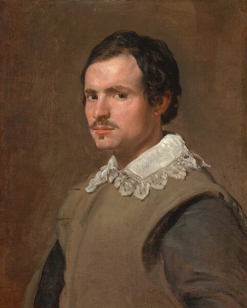 Shown from the chest up, a pale-skinned young man with dark hair and a brown mustache and goatee looks at us from the corners of his dark eyes in this vertical portrait painting. His body and face are angled to our left, and his left eyebrow, closer to us, is slightly cocked while other is low over his other eye. He has a straight nose, a square, set jaw, and his pink lips are closed. His short, espresso-brown hair lays flat against his head but curls around the ear we can see. He wears a pecan-brown vest over a black, long-sleeved shirt with a white, lace-edged collar at the neck. His garments blend into the peanut-brown background so the light falling from the upper left highlights his features and white collar.