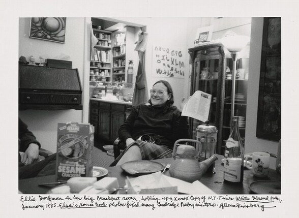 Ellie Dorfman in her big breakfast room, holding up a Xerox copy of N.Y. Times White Shroud Poem, January 1985. Elsa