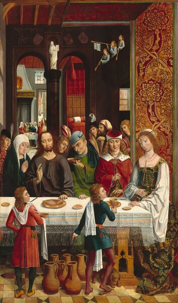 Three men and two women sit or stand along the opposite side of a long table, with more people looking on behind them and another cluster of four people around a round table next door to a bedroom in the background of this tall, vertical painting. All the people have pale skin. The long table stretches nearly the width of the painting and seems close to us. Near the left edge of the painting, a woman wearing a teal-blue robe over a white head scarf holds her hands together in front of her chest, as if in prayer, and she looks down and to our right toward the tabletop. Next to her, a bearded man wearing a loose, plum-brown robe, Jesus, holds his right hand, to our left, up in front of his chest with his first two fingers raised, and the other hand rests on the table. His long, wavy brown hair hangs by his face and he looks down toward the table with hooded eyes, his head tilted slightly to our left. Gold lines radiate out from the woman and Jesus’s heads. At his left shoulder, to our right, a man wearing a sky-blue cap and an emerald-green robe holds an oval-shaped bowl filled with a red liquid toward Jesus with one hand and the other rests on the table. He looks to our left with light brown eyes under arched brows, and he has deep wrinkles across his forehead, at the corners of his eyes, along his chin line, and around his mouth. To our right and at the end of the table, a young, cleanshaven man sits next to a woman. Both have wavy blond hair and they look down toward the table. The man wears a crimson-red cap and a white fur-lined red cloak with a gold, jeweled clasp lined with teardrop pearls. His right hand, to our left, is lifted toward the woman sitting next to him. The woman wears a pearl-and-jewel headband around a white cloth that drapes down the back of her head. Her pine-green dress is patterned with shimmering gold, stylized leaf designs and has full, loose, white sleeves. She wears three gold rings on the hand resting on the table and two jeweled, gold bands on the other, which rests on her belly. Two younger people, both with brown, shoulder-length hair, stand on our side of the table, facing away from us as they look toward the woman to our right. The one to our left wears a brick-red tunic and he holds a shallow, round bowl. The one to our right wears teal blue and holds a gold goblet on the table. With his other hand, he points down at six tall jugs on the geometrically patterned floor, and a brown dog stands at his feet. The table is covered with a white cloth, which is decorated with bands of stylized leaves and borders on the side facing us. Along the bottom, above long fringe, an inscription reads, “AVE GRACIA PLENA DOMINVS TECV BENEDICTATV INMVILEDIDVS ET BENEDICTVS.” Two gold plates, a few pieces of round, flat bread, and two knives are spaced along the tabletop. The room with the table has two tall, narrow arches of wood or dark stone at the back of the space. At the top of the column separating the arches, there is white statue of a man holding up two rounded tablets. Behind the group at the table, one person stands to our left, another at the center, and a trio of men stand to our right. Farther back to our right, a doorway leads to a room with a bed covered with a ruby-red cover and a white pillow. Next to the bedroom, and over Jesus’s right shoulder, one woman and three men sit or stand around a round table in front of a tall mantle. One of the men holds a large, pewter-silver pitcher up to his lips and the other three look on. The round table is covered with a white cloth and set with a few dishes. A door opens onto a street view lined with buildings beyond.