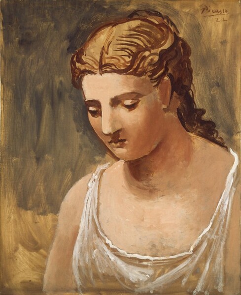 Shown from the chest up, a young woman with peach-colored skin standing angled to our left takes up right two-thirds of this vertical portrait painting. Her blond hair is accentuated with strokes of tawny brown and gathered at the back of her head. A long tendril cascades down her back. She is lit from the upper left, which casts the back of her head in shadow. Her eyes are downcast, and her long nose and small mouth are set in a round face. She wears an almost sheer white, sleeveless dress with a low scooped neckline. A background painted with long streaks of fawn brown and tan fills the space behind her. The artist signed and dated in the upper right, “Picasso 22.”