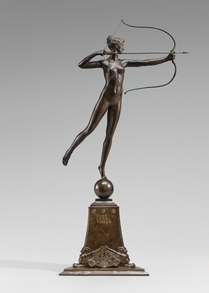 Cast in bronze, this free-standing sculpture shows a slender, young, nude woman balanced on the toes of one foot on a globe as she pulls back an arrow in a bow. The smooth, dark brown bronze surface is touched with hints of honey gold where light catches it, as on her chest and along her outstretched leg. In this photograph, her body is angled to our right, and she turns her head so we see her profile facing our right. She balances on the ball of her left foot, farther from us, as she lifts her nearly straight right leg up behind her. Her left arm extends straight, holding the bow. With her other hand, she pulls the long arrow and bowstring back to nearly touch her right shoulder, so the arms of the bow are almost parallel. Her wavy hair is pulled up in a bun on the crown of her head. She has a long, straight nose, and her lips are closed. The ball on which she stands balances on a rectangular, slightly flaring plinth, which is about half the height of the woman. The bottom corners of the plinth nestle between the wings of two sphinx-like creatures with animal faces, horns, wide, lion-like paws, and wings. Below a row of three stylized rosettes near the top edge of the plinth, the cast inscription reads, “DIANA OF THE TOWER.”