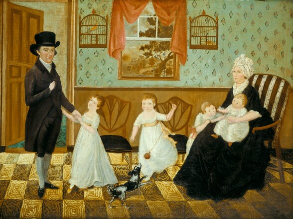 A man, woman, four children, and a black and white dog stand and sit in a row in a wallpapered room with a checkerboard patterned floor in this horizontal painting. The woman and children have pale, peach skin and the man has a ruddier complexion. The man stands to our left wearing a tall, black, brimmed hat, a black coat, a high-necked white shirt or kerchief at the neck, and knee-length breeches over white stockings. His pointed shoes and breeches have silver and gold buckles. He stands with his body angled to our right but he turns to look at us. He tucks his right hand, closer to us, into the opening of his jacket and he clasps the hand of a young girl with his other. This young girl and the three other children all have blond hair and green eyes, and all wear white, scooped-neck garments. The girl holding the man’s hand turns to look up at him, and she touches his coat with her other hand. To our right, another child swings a ball at the end of a long string for the small dog who leaps up for it. Near the right edge of the painting, a woman sits in a high-backed, upholstered chair with a baby on her lap and a toddler leaning on her legs. The fabric of the chair is patterned with brown and white stripes, with a vine pattern on the white stripes. The woman’s body is angled to our left, and she looks in that direction, almost in profile. She wears a ruffled white bonnet, a long black dress with white at the neck and elbow-length cuffs, and a strand of gold-colored beads. She has brown eyes and rosy cheeks, and her pink lips are closed. The baby sitting in the woman’s lap reaches for the ear of the toddler leaning on the far side of the chair, elbows propped on the woman’s legs. A door behind the man is ajar, leading into another room with a diamond-patterned floor. The wall running behind the group has brown paneling along the bottom half and the top half is patterned with pine-green diamonds on a seafoam-green background. Two wooden chairs with upholstered seats sit against the wall behind the children. Above the chairs, a window opens onto a landscape with a tree, fence, and hills painted in peanut brown and beige. A rust-red curtain has been pulled up and to the sides of the window, which is flanked by two bird cages, each holding one butterscotch-yellow bird. The floor is made up of a checkerboard pattern of harvest yellow and brown squares that have been painted with wavy lines to suggest texture or pattern. The perspective of the room is flattened, and the proportions of some of the people are a little off, especially the man, whose head seems too large for his body. The poses of the people are also stiff, though some of them are connected by gestures.