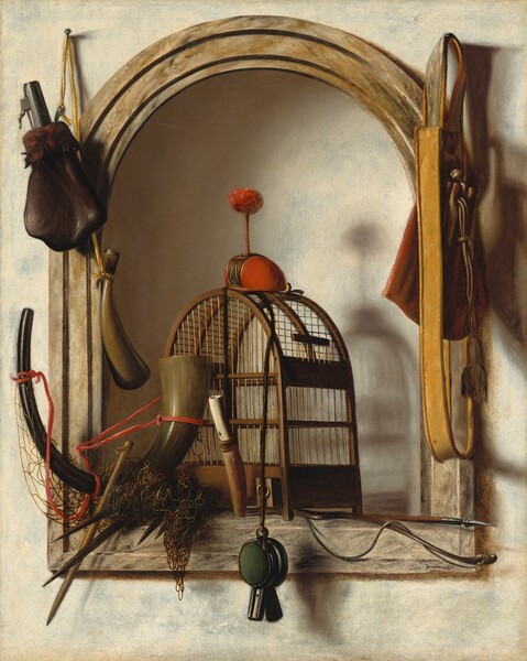 A cage, net, hunting horn, powder bag, pouch, two whistles, a bow and arrow, and a small, round hood for a bird are arranged in and around an arched niche set into a cream-white wall in this vertical still life painting. The objects are lit from our upper left so soft, slate-gray and powder-blue shadows are cast across the walls. The niche is framed with a wood border. Centered in the niche, the wooden cage has an arched top and closely spaced bars. The hood sitting atop the cage is a scarlet-red cap that would fit onto the head of a falcon. It is topped with a red pompom on a short stick, like an antenna. A sheathed knife with a bone-white handle and a long, curving, hunting horn lean against the front of the cage. The horn lightens from black where one would blow into the horn to a shimmering sage green at the wide end, which rests against the cage. A bow and arrow lie across the floor of the niche, under the cage, and a tangle of netting is tied to the horn, near the foot of the cage to our left. A pine-green whistle is affixed to or looped through the top of the cage, under the falcon’s hood, and hangs down past the ledge. A powder horn and bag hang on a canary-yellow cord looped over a nail driven into the wall over the alcove, to our left, and a pouch with a tassel hangs from a nail to our right.