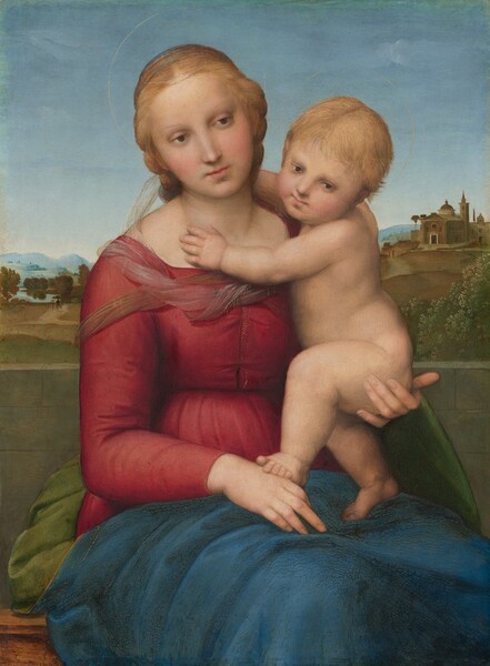 A woman and nude child, both with pale skin, sit in front of a deep landscape in this vertical painting. Shown from about the knees up, the woman’s body is angled slightly to our right, and she supports the baby under his bottom with her left hand, on our right. She wears a long-sleeved, crimson-red dress with a sheer, nearly translucent fabric around her shoulders. Fern-green drapery, nearly matching the color of the grassy landscape, is gathered behind her hips, and a deep lapis-blue cloth lies across her lap. Her blond hair is pulled back. She has a straight nose, rosy cheeks, and her pink lips are closed. Her head tilts to our left, and she gazes down and to our right with brown eyes. Her right hand, on our left, rests in her lap, and she holds the baby with her other hand. The blond baby half sits, half stands on the woman’s lap so one foot rests on the hand in the woman’s lap. He reaches his arms around her neck and turns to look over his left shoulder, also gazing down and to our right. Thin, gold halos above their heads are barely visible against the pale blue sky. An expanse of green grass extends behind the pair leading to a cluster of trees to our left and buildings on a distant hill to our right. Hazy blue hills line the horizon in the distance below a blue, nearly cloudless sky.