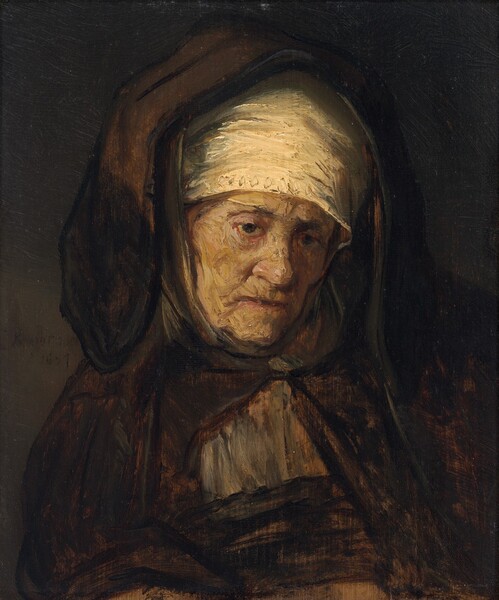 Shown from the chest up, a pale-skinned older woman looks down and to our right in front of a shadowy background in this vertical painting. Brushstrokes are visible throughout, especially in the woman’s face and clothing. Her shoulders square toward us but she looks down and to the side with heavy-lidded, sunken eyes. Her face is deeply lined between her eyebrows, down the sides of her nose, and at the corners of her mouth. Her cheeks sag in jowls on either side of a fleshy chin, and her thin lips are set in a line. A cream-white cloth wraps across her forehead and covers her head. An earth-brown, voluminous hood rests across the crown of her head and droops to her shoulders, where it meets the cloak fastened at her throat over a steel-gray garment. The background is also dark brown and signed to our left near the woman’s shoulder, “Rembrandt 1957.”