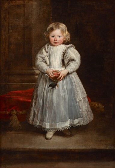 A young girl with ivory-colored skin, round, rosy cheeks, and blond hair holds an apple and wears a full, ankle-length, silvery white dress with puffy sleeves in this vertical portrait painting. She stands with her body slightly angled to out left and she turns her face to look at us with large, dark blue eyes under faint brows. Her wavy blond hair falls to her chin and glimmers gold where it catches the light. Her nose and cheeks are flushed and her rose-red lips are closed in a slight smile. She holds a red and green apple with both hands at her waist. Her dress has a high neck and voluminous, puffy sleeves with lace at the cuffs. Her dress is covered by a smock down the front and an apron over the full skirt. The apron is edged with lace and seems to be smooth, which contrasts with the textured appearance of the skirt and sleeves. The rounded toes of her cream-white shoes poke out under the hem of her dress. She stands on a platform or on a step, and a crimson-red cushion with gold trim and tassels rests on the floor behind her. To our left, a thick, square column rises from a tall base and reaches off the top edge of the composition. The background to our right is dark with shadow that contrasts sharply with her hair, complexion, and dress.