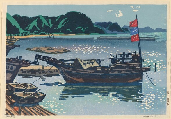Several rowboats and larger boats are pulled in along a sandy shoreline, surrounded by a body of glimmering, topaz-blue water with emerald-green hills in the background in this horizontal, color woodcut print.