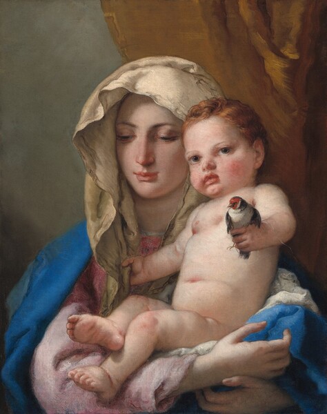 Shown from the chest up, a young woman faces us holding a nude baby in her arms in this vertical painting. They both have pale, peachy skin with pink cheeks. The woman has an oval face with a thin nose, and her coral-pink, bow mouth is closed. She looks down and to our left with dark eyes under arched brows. Her hair is covered by a bone-white veil, and an azure-blue mantle is draped over her rose-pink robe, which is a darker pink at the shoulders. She cradles the plump child in her crossed arms. The baby has short, wavy, copper-red hair framing a round, flushed face with a button nose, peach lips, and hazel eyes that look at us. He holds a bird in his left hand, on our right. The bird has an off-white body with charcoal-gray wings and neck, and a strawberry-red face. The baby grasps one end of the woman’s veil with his other hand. The background is concrete gray to our left, and the right half is covered by a ginger-brown curtain.