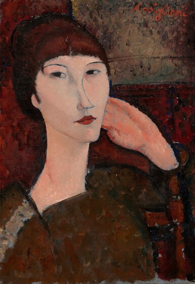 A woman with peachy skin and dark auburn hair is shown from her chest up sitting in a wooden chair in this vertical portrait painting. Her body is angled to our right, and her left arm, farther from us, rests on the back of the chair so the fingers of that hand rest alongside her left cheek. Her face is angled to our right but her dark eyes cut back to look at or toward us from the corners of her almond-shaped eyes. She has thin, gently arched brows, a long, sloping nose, and her burgundy-red lips are closed. Her features are outlined with delicate, dark gray or black lines. Bangs sweep across her forehead, and her hair looks like it might be pulled up and back. Her rust-brown garment has a square neckline, and a lighter strip of smoke gray and sky blue runs along her right shoulder, closer to us. She sits in front of an indistinctly patterned wine-red wall, with a lighter, tan-colored rectangle in the upper right corner. The background, her clothing, and the hand by her face are painted with areas of mottled color but the skin of her face seems smooth. The artist signed the painting with bright red letters at the upper right, “Modigliani.”