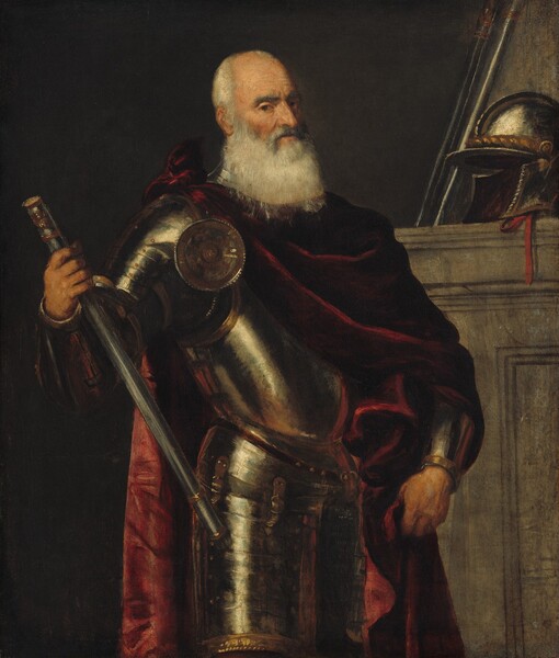 Shown from the thighs up, an older, balding man with a long white beard stands wearing a full suit of armor draped in a burgundy-red cloak in this vertical portrait painting. The man’s body is angled to our right, but he looks at us from the corners of his dark eyes. He has bushy gray brows, a bumped nose, high cheekbones, and his lips are closed. He has short white hair around a receding hairline, and his beard falls to his chest. His pewter-gray armor gleams darkly with cream-white accents. With one hand, he braces a baton against his right hip, to our left, and with the other gathers the folds of his cloak down by that side. The cloak is tied over one shoulder and falls heavily around his body. His helmet rests on a shoulder-high gray stone structure, perhaps a mantle or a ledge, behind the man to our right. The rest of the background is charcoal gray.