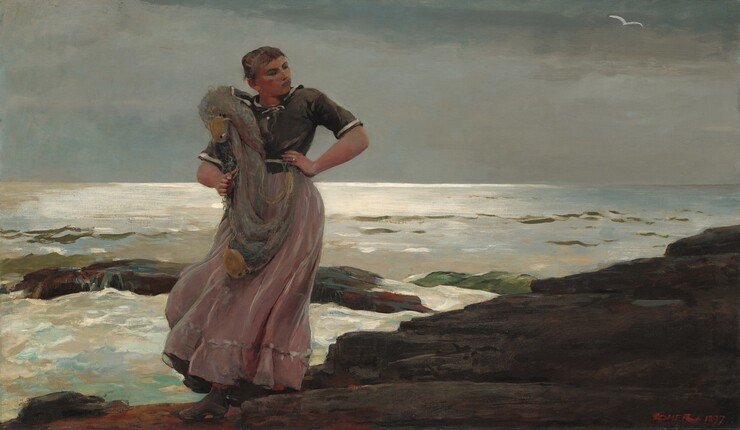 A young woman with flushed, peachy skin stands on a rocky shoreline with a fishing net slung over one shoulder in this horizontal painting. Her body faces us, and she looks off and down to our right. Her left hand, to our right, is planted on her hip, and she clutches the gray net with her other hand. Her head tips toward us as her chin tucks back toward her shoulder. She has a round jaw, a straight nose, and her pink lips are set in a line. Her brown hair is pulled back and up, and bangs sweep across her forehead. Her ash-brown shirt has white bands echoing the neckline, across the waist, and around the hems of the elbow-length sleeves. Her skirt is painted with strokes of mauve pink and silvery gray. A stiff breeze sweeps the skirt to our left and reveals a glimpse of red stockings over sturdy gray shoes. The dark shoreline angles from the lower left corner to halfway up the right edge of the composition. White water breaks over boulders in the surf beyond. Light reflects brightly along the horizon, which comes just over halfway up the painting. A white bird flies in the pewter-gray sky. The artist signed and dated the painting in red in the lower right corner, “Homer 1897.”