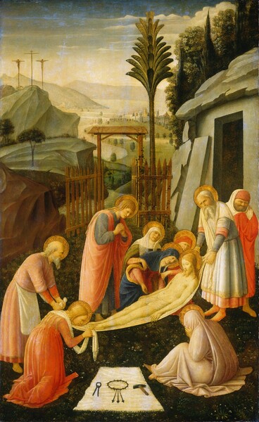 Nine people are gathered in a landscape around the gaunt body of a young man being carried on a cloth in the lower half of this vertical painting. All the people have pale skin tinged with yellow, and all but one have shiny gold halos. The space is framed to the right by a stone-gray structure with a squared opening and, to the left, with a brown, rocky outcropping. Tall cypress trees and sage-green vegetation grow up and over the structure to our right. The bearded young man, Jesus, is laid out horizontally with his feet to our left, on a flax-yellow cloth carried by two elderly men. He is nude except for a white cloth across his hips, and there are tiny red slashes on the hand and foot we can see, and over his right ribs, farther from us. Just beyond the body, a woman draped in a marine-blue robe bends to gaze at Jesus’s face while being supported by two other women. A young, cleanshaven man in a coral-pink robe over a steel-gray garment stands by them, on our left, with his head lowered and hands clasped. On our side of the body are two women with their backs to us. The woman on the left kneels at Jesus’s corpse with her head bent as she wipes his feet. The woman on the right sits on the ground with her robe drawn over her head, and she covers her face with her hands. On the ground between them, a hammer, the ring of thorns with three arrows extending from it, and a nail puller lie on an white cloth. The only person without a halo is a bearded man standing to our right, closest to the opening in the structure. He wears a red robe and cap draped with a white cowl. The ground beneath the group is carpeted with pine-green grass, and a sprinkling of white dots suggests small flowers. A palm tree stands just outside a tall, narrow wooden gate beyond the group. The gate opens onto a landscape with a river winding to meet a town and hazy mountains in the distance. A tall, steep, laurel-green hill to our left is topped with three wooden crosses, and bodies hang from the crosses to either side. A few bands of clouds float across the sky, which deepens from ivory white at the horizon to azure blue along the top edge.