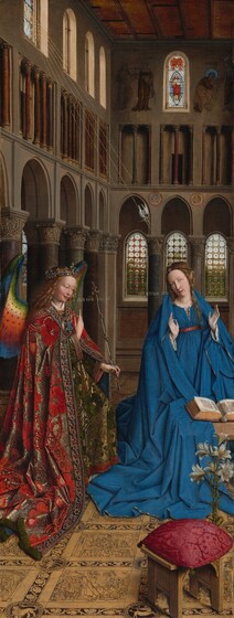 A woman and winged angel, both with pale, peach skin, are situated in a church interior in this tall, narrow painting. To our left, the angel has long, blond, curly hair, smooth skin, and is smiling. The wings are outlined in royal blue, and they blend from blue to green to yellow to crimson. The angel holds one hand, closer to us, up at chest height with the index finger subtly pointing upward. Holding a long scepter in the other hand, the angel angles their body toward the woman to our right. The angel wears a gold jewel and pearl-encrusted crown and a jeweled long, voluminous robe in scarlet-red and shimmering gold brocade. The neck and along the opening down the front are lined with pearls and jewels. The angel looks toward the woman, who wears a royal-blue dress tied with a red belt at the high waist. Her long brown hair is tied back but one tendril falls over her left shoulder, to our right. She kneels facing us with her raised hands facing outward. Her head is tipped a bit to our left, and she looks up and into the distance to our right with lips slightly parted. She kneels behind a book lying open on a low table. A vase of white lilies and a red cushion lies on the floor in front of the table, close to us. The floor is decorated with people and scenes outlined in black and set into square panels, as if inlaid with wood. The church behind and above the people has a row of tall, narrow arches with bull’s-eye glass windows. A walkway lined with columns runs above the arches, and sunlight comes in through arched windows under the flat wood ceiling. A white dove flies toward the woman on gold lines from a window at the upper left of the painting. Latin words painted in gold capital letters are exchanged between the people. The angel says, “AVE GRA PLENA.” The letters of the woman’s response are painted upside down and backward: “ECCE ANCILLA DNI.”