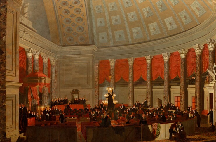 We look across a cavernous room with a half-domed ceiling where more than a hundred men are gathered at desks and theater-like boxes in this horizontal painting. Almost all of the men have pale, peachy skin and wear black suits with white high-pointed collars. The desks curve in a half-circle facing our left, where two candelabras sit on a dais, a canopied space with polished columns. Seven more columns lining the rounded space are also speckled with fawn brown, bronze, copper, and muted moss green. They have white capitals carved with leaves ands scrolls. Crimson-red curtains hung between the columns have been gathered up along their centers so they drape down to each side. The space is lit by a three-tiered chandelier near the center of the composition. The chandelier has been lowered and a man, backlit in silhouette, stands on a ladder and reaches for a light on the top tier. The other men sit singly or in groups at the desks or gather in small groups throughout the space. The D-shaped rows of desks are enclosed within a curving, waist-high wall. To our right, on our side of the wall, a pair of boys or men lean over an open box that is lit inside. A few people look on from a second-level balcony to our right. This includes a trio of men all wearing black. In the next bay, a man with medium-brown skin wears Pawnee attire with a tall headdress, necklaces, and what seems to be a fur-lined cloak. He looks out at us. A clock on the wall near him reads 6:14. The domed space has nested, ivory-white square or octagonal panels within gold borders. At the center of each panel is a six-petaled, gold flower. The artist signed the work as if he had written his name and date on the base of the wall to our left: “S.F.B. MORSE pinx 1822.”