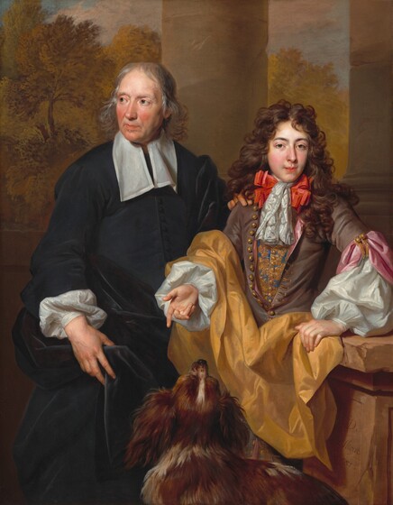 An older man, a young man, and a dog stand on a verandah that opens onto a landscape in this vertical portrait painting. The men are pale skinned and shown from the knees up. The older man stands on the left with his head turned to look off in that direction. Long, silver-gray hair frames his flushed face. Bushy brows curve over his dark gray eyes, and deep creases line his long nose. His plump pink lips are closed between a thin white mustache above and a dot of a beard below. A long white collar hangs down the chest of his lead-gray jacket. His right sleeve, on our left, is turned back to show the cuff of a puffy-sleeved white shirt underneath. That hand holds gleaming velvet-black fabric, which is gathered at his waist and falls to his knees. His other hand rests on the shoulder of the young man to our right. That man’s oval face is framed by thick, shoulder-length, curly, chestnut-brown hair. He gazes at us with amber eyes under slender brows. He has flushed cheeks, a narrow nose, and coral-red lips are slightly parted. A bright orange ribbon tied under a white brocaded ascot around his neck is wider than his face. His russet-brown jacket is unbuttoned to show an embroidered gold and azure-blue vest underneath. A wide pink sash is fastened around his left elbow, on our right, and billowing white sleeves extend from the shorter sleeves of the jacket. He holds his right hand, to our left, palm up with his index finger extended toward the dog in front of him, who has turned to look up. Shown from the back, the dog has long, glossy, coffee-brown fur with some white streaks. The young man’s other hand rests on a chipped stone balustrade next to him. The artist signed and dated the work as if he had carved the front face of the balustrade to read, “N. De Largillierre F. 1685.” Two stone columns rise to either side of the young man and give way to a tree-filled landscape under a muted blue sky above.