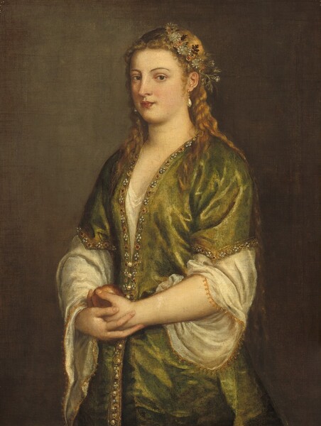 Shown from about the hips up against a sable-brown background, a pale-skinned woman stands cradling an apple with both hands at her waist in this vertical portrait painting. Her body and face are angled to our left but she looks out at us from the corners of her eyes. She has dark brown eyes under curving brows, a straight nose, smooth cheeks, and her coral-red, heart-shaped lips are closed. A crown of parchment-white and rust-orange flowers with sage-green and brown leaves sits akimbo, close to the ear we can see, over her honey-brown hair, which falls over her shoulders and down her back to her waist. Teardrop-shaped pearls hang from her ears. She wears a sea-green gown with elbow-length sleeves over an eggshell-white garment, which has voluminous sleeves edged with gold. The green garment is lined with pearls, jewels, and gold embroidery around the hem of the sleeves and down the front. The muted red apple rests in one hand, which is cupped in her other hand at her waist. The woman is lit from our left in a warm glow against the brown background.