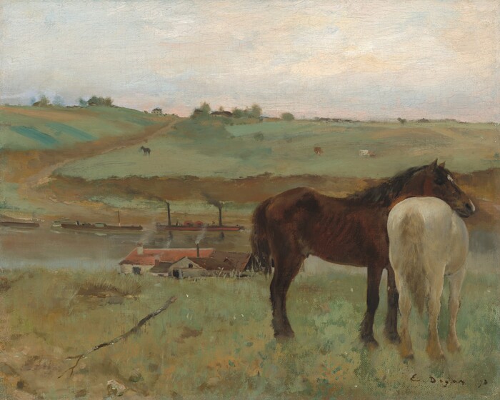 Two horses, one dark brown and one cream white, stand together to our right against a landscape with rolling, sage-green hills and a river or canal in this horizontal painting. Near us, facing our right in profile, the brown horse rests his head across the back of the white horse, who stands with its tail toward us. The horses stand along the ridge of a grassy hill that dips beyond us to a waterway crossing the width of the canvas. Several buildings line the shore closer to us. At least one building has parchment-white walls and a red roof, and another has peanut-brown walls with a darker, chocolate-brown roof. More rooflines are nestled between, and gray smoke wafts from several chimneys. Long, low boats float near the opposite shore. The land rises in a hill across the water with more horses or other animals in the far pastures. The scene is loosely painted, and the background is the most indistinct, so some details are difficult to make out. Touches of brown and green suggest trees and perhaps more trees and buildings along the hill in the distance. The ivory-white sky is touched with pale, petal pink and a hint of blue near the horizon. The artist signed and dated the work with dark paint in the lower right corner: “E. Degas 71.”