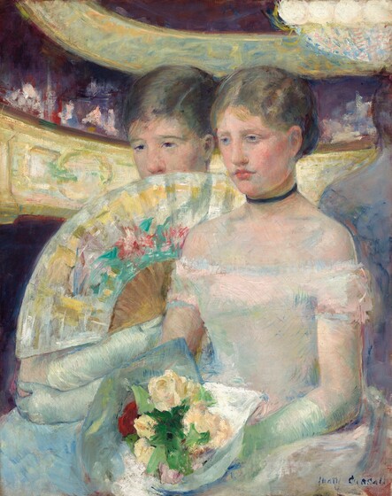 Shown from the knees up, two young women with pale, peachy skin wearing white gowns sit close together and almost fill this vertical painting. The women are angled to our left and look in that direction. The young woman on our right has a heart-shaped face, dark blond hair gathered at the back of her head, and light blue eyes. Her full, coral-pink lips are closed, the corners in greenish shadows. Her dress is off the shoulders, has a tightly fitted bodice, and the skirt pools around her lap. The fabric is painted in strokes of pale shell pink, faint blue, and light mint green but our eye reads it as a white dress. She wears a navy-blue ribbon as a choker and long, frosty-green gloves come nearly to her elbows. She holds a bouquet in her lap, made up of cream-white, butter-yellow, and pale pink flowers with grass-green leaves and one blood-red rose. Her companion sits just beyond her on our left and covers the lower part of her face with an open fan. The fan is painted in silvery white decorated with swipes of daffodil yellow, teal green, and coral red. She has violet-colored eyes, a short nose, and her dark blond hair is smoothed over the top of her head and pulled back. She also wears long gloves with her arms crossed on the lap of her ice-blue gown. Along the right edge of hte painting, a sliver of a form mirroring the torso, shoulder, and back of the head of the young woman to our right appears just beyond her shoulder, painted in tones of cool blues. Two curving bands in golden yellow and spring green swiped with darker shades of green and gold arc behind the girls and fill the background. The space between the curves is filled with strokes of plum purple, dark red, and pink. The artist signed the lower right, “Mary Cassatt.”