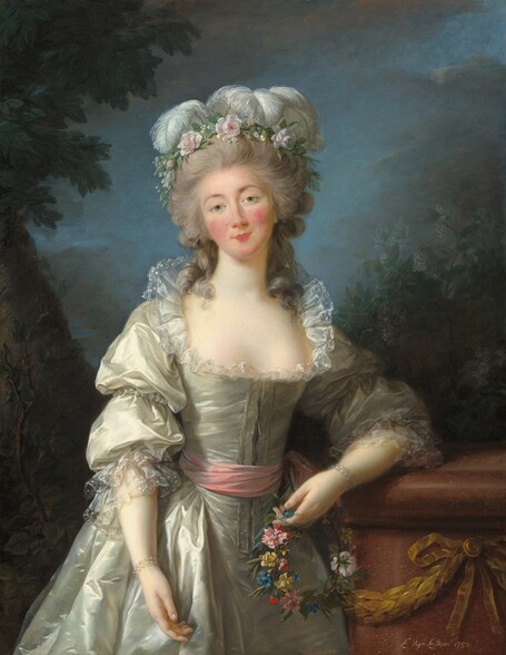 Shown from the knees up, a woman stands facing and looking at us with her head tilted a little to our left in this vertical portrait painting. She has pale skin, a heart-shaped face with rosy cheeks, and a rose-pink bow mouth. Thin, arched, sable-brown eyebrows frame her gray eyes. A wreath of pale pink flowers and curling white ostrich feathers crowns her long gray hair, which is piled high on her head. Loose curly tendrils brush both shoulders. Her glowing, silver satin gown is trimmed with delicate sheer lace around the wide, plunging neckline and sleeves, and has a pink sash around her narrow waist. Pearl bracelets adorn her wrists. She leans to her left, our right, to rest her left elbow against a waist-high, cinnamon-brown stone pedestal, which is decorated with a bronze-colored garland and bow on the side facing us. A ring of blue, yellow, red, and pink flowers, woven with strands of ivy, dangles in the hand resting on the pedestal. Her right hand hangs loosely by her side. Along the left edge of the dimly lit background, a tree with a thick trunk angles into the upper left corner. A smaller sapling grows just in front of it. On the right, bushes with olive and fern-green leaves dotted with lilac-purple flecks rise above the pedestal. Dark clouds fill most of the top third of the canvas but they part around her head to reveal the soft blue sky. The artist signed and dated the work in white in the lower right corner, “L. Vigée Le Brun 1782.”