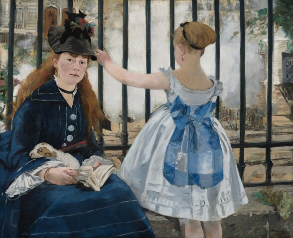 To our left, a young woman sits facing us on a low stone wall at the base of the vertical, black bars of an iron fence and a young girl stands facing away from us to our right in this horizontal painting. Both have pale skin. The woman looks directly at us with dark eyes as she holds an open book, a closed red fan, and a sleeping brown and white puppy in her lap. Her long auburn hair falls down over her shoulders. Her navy-blue dress is accented with white piping on the skirt, collar, and sleeves, and has three large, white buttons down the front and her black hat is adorned with two red poppies and a daisy. The girl wears a sleeveless white, knee-length dress belted with a marine-blue sash tied in a large bow at her back. The girl’s blond hair is pulled up and tied with a black ribbon. She raises her left hand to grasp the bar of the fence she faces. A bunch of green grapes lies on the low wall to our right. A plume of steam fills much of the space beyond the black fence, which spans the width of the painting and extends off the top edge. A few details can be made out beyond the fence, including a stone-gray building with two wooden doors to our left and a bridge along the right edge.