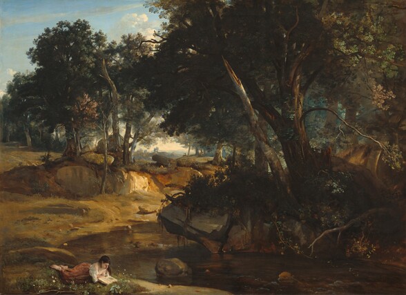 A young woman reclines and reads a book near a stream that winds through a wooded landscape in this horizontal painting. Painted with rich evergreen and pine greens, trees tower along the riverbanks and fill most of the painting. The olive-colored water seems to have cut straight down over time, creating high banks painted with tones of caramel and honey browns. Steel and slate gray boulders are scattered in intervals near the river. Deep in the hazy blue distance, mountains line the horizon, which comes halfway up the composition. In the lower left corner of the painting, close to the river, the woman lays on her stomach as she props herself up on her elbows to read. She has pale white skin and her long, dark hair falls over her shoulders. Her white shirt hangs low over her shoulders, and her rose-pink skirt falls just short of her bare feet.
