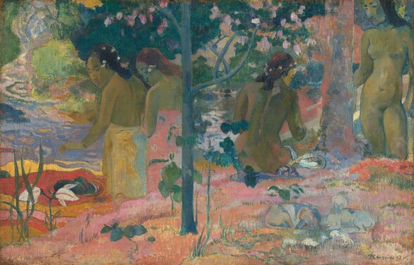 Four young women with olive-green-colored skin shaded with cool blue stand or sit in a vividly colored landscape surrounded by trees in this horizontal painting. A slender, spruce-blue tree divides the picture just to our left of center. The ground around the tree spans the width of the composition and is carpeted in coral orange, carnation pink, and lavender purple with a handful of emerald-green saplings and tufts of grass. A pair of young women are to each side of the central tree, and a body of water extends across the composition just beyond this bit of land. To our left, the two women’s bodies face away, and they look back over their left shoulders at us. The girl on the left has black hair and wears a honey-orange and pale blue fabric wrapped around her waist. The girl next to her has copper-red hair with a pink cloth wrapped around her chest. They stand by or in the water so are shown from the knees up. The water there is made up of swirling pools of flame red and golden yellow bordered by lilac purple and peacock blue. On the other side of the tree, a young woman with white flowers in her brown hair sits on the ground, also with her back to us. The fourth faces us along the right edge of the canvas. She has black hair and stands next to and touches a thicker tree trunk with one hand. These two women are nude. The water beyond them is painted with patches of rose pink, lemon yellow, and ice blue. Areas mottled with teal, honeydew, and bottle green suggest shrubs and trees lining the far side of the water. Closer inspection reveals two ghostly, pale blue dogs lying on the ground near the lower right corner. The artist signed and dated in lower right, “P Gauguin 97.”