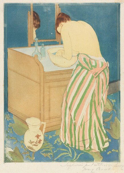 A pale-skinned woman bends over a basin of water on a washstand in this vertical, colored print. The woman is angled away from us so only her ear and the curve of her forehead are visible beyond her hunched shoulder. Her upper body is bare, her dress having been unfastened so it hangs around her waist. The dress is striped with grass green, rose pink, and the cream white of the paper. Light gleams on her auburn hair, which is tied up and back. She cups her hands in the light blue water of the faintly yellow basin. Two bottles sit at the back corner of the washstand, and a mirror reflects the top of her head. The fawn-brown washstand is boxy, and a handled white pitcher painted with muted pink flowers is at the front left corner, which is closest to us. The wall beyond the washstand is sapphire blue, as is the carpet, which is also patterned with celery-green leaves. A mark with an oval, or a mirrored C, over an uppercase M, is stamped in royal blue at the bottom center of the print. The sheet is inscribed with graphite across the right half of the bottom margin, “Imprimée par l'artiste et M. Leroy Mary Cassatt.”