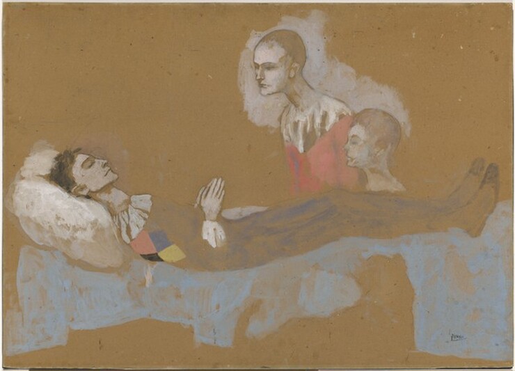A young man and boy look at a man laid out on a bed in this horizontal composition. All three people have white-colored skin and are loosely painted, as is the incomplete setting. The man lies with his eyes closed on the bed with his head to our left and feet to our right. He is on a baby-blue field, perhaps a blanket, and his head is propped up on a thick white pillow. He has black hair and delicate features, and his hands are together in prayer over his belly. The white ruffled collar and a diamond made up of smaller red, blue, yellow, and black diamonds are painted on his shoulder. The rest of his body is blocked in loosely with lapis blue except the cuff we can see, which is bright white. The young man and boy look on from near the man’s shins on the far side of the bed. Both have close-cropped hair. The young man cranes his neck forward, and his head and shoulders are surrounded by a white field against the brown cardboard on which this is painted. His garment is white over the shoulders and red on the torso. Only the head and neck of the boy are visible beyond the prone man. The artist signed the work in black in the lower right corner, “Picasso.”