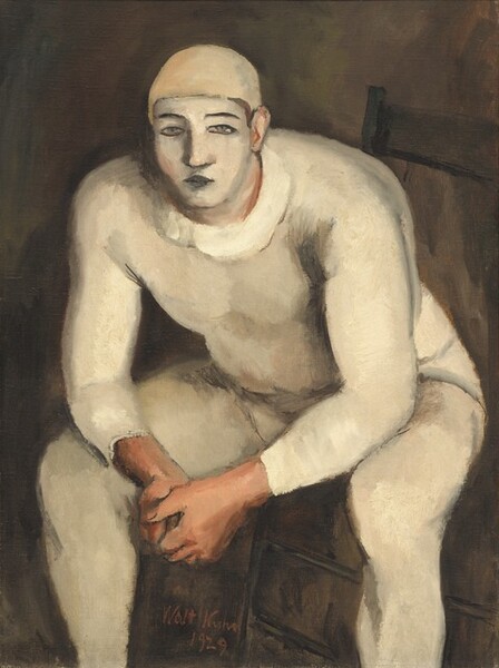 A stocky, muscular man with his face painted white and wearing a skin-tight, oyster-white costume sits on a wooden chair, leaning forward toward us with his elbows resting on his knees in this vertical painting. The man nearly fills the canvas, and his feet are cropped by the bottom edge. His body is angled slightly to our left with his knees spread wide, but he looks out at us. He wears a pale, beige-colored cap and his cream-white bodysuit may have a loosely painted, wide collar. His nearly straight eyebrows and closed lips are painted black, and his narrow gray eyes are outlined in black, against the white oval of his painted face. His clasped hands, ears, and his skin visible along the edges of his makeup are pale peach. The background is earth brown. The artist signed and dated the work with red paint between one of the man’s legs and the leg of the chair, near the lower center: “Walt Kuhn 1929.”