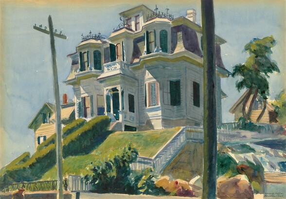 From the bottom of a hill, we look up at a house with white siding and pine green shutters flanking several bay windows in this horizontal watercolor painting. Two powerlines rising from the street in front of us visually frame the house, and the right-hand pole reaches off the top edge of the composition. Spring green grass and trimmed box hedges climb presumably flank stairs leading up to the front door, which sits within a narrow, covered porch. There are two bay windows on the first floor, one on either side of the central porch. Three-sided bay windows on the second floor mirror those on the first, and the central window, over the front door, also sits within a narrower bay. The uppermost story is seen only as a pair of windows either set into a gable or dormer. The roof on the second level, around the bay windows, is slate gray and the shadows are painted deep plum. Curling ironwork lines the second-story bays in front of the dormer and a chimney rises to our right. The house is silhouetted against a pale blue sky with a tree to our right and white picket fencing descending along the line of the hill below. Next to the fence, it seems that the ground drops off to a sheer wall, perhaps to an adjacent street. Two smaller homes with pale butter-yellow siding peek over the hill in the distance, one on each side of the house. The artist signed and dated the painting with the location in blue paint in the lower right corner: “Edward Hopper Gloucester 1924.”