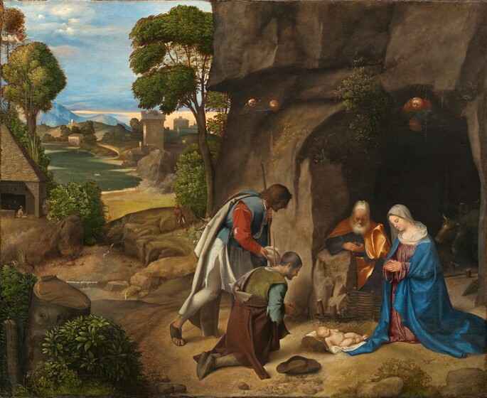 Four people with pale skin are gathered to our right in a landscape, their heads bowed down toward an infant who lies on a white cloth on the ground in this horizontal painting. The nude baby has a rounded belly, chubby limbs, and short blond hair. To our right and near the edge of the panel, a woman kneels with her hands in prayer, looking toward the baby so she faces our left in profile. She wears a lapis-blue robe over a rose-pink dress, and a white cloth covers her head and shoulders. Behind her and to our left, a man with a white beard, wearing a golden yellow robe, sits or kneels next to a rock at the mouth of a cave cut into a rocky outcropping that extends off the top of the composition. To the left of the baby and at the center of the foreground, a pair of men wear tattered clothing and hold shepherd’s staffs. The man closer to us kneels with his hands pressed together in prayer as the man behind him bends his knee as if to kneel. The landscape recedes deep into the distance on the left half of the painting with a winding river, houses and other buildings, grassy hills, and mountains beneath a blue sky. A small winged angel wearing white looks down on the scene from the upper left corner.