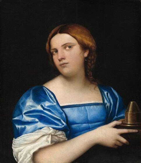 A young woman with a pale, peachy skin is shown from waist up, wearing a shimmering, royal-blue dress in this vertical painting. Her body is angled to our right as she holds a metal object, perhaps a vessel or incense burner, in her hands by her chest. She turns and tilts her head to our left, but then looks back across her body, off to our right with flint-gray eyes. She has a full, oval-shaped face with a straight nose, smooth cheeks, and her pale pink lips are closed. A gray pearl earring hangs from the ear we can see. Her auburn-brown hair is parted down the middle, and loosely pulled back into a braid that brushes her left shoulder, to our right. The blue dress has a square neckline and a fitted bodice. Light glints off the fabric, shading it from royal to sapphire blue. A voluminous white sleeve is rolled back to her right elbow, to our left. That arm and hand nearly span the width of the painting as she holds the vessel, which has a conical top, near the lower right corner of the composition. The background is solid black.