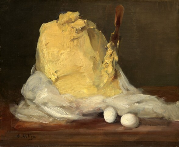 A mound of creamy, yellow butter sits to our left of center on a wooden table against an olive-green background in this horizontal still life painting. White cloth, presumably the wrapper or cover, is pushed down around the base of the mound to expose the heap of butter. The top of the mound has a few gouge marks and furrows. A long, narrow wooden paddle is stuck vertically into the right side of the mound, and is submerged almost up to the handle in butter. Two white eggs rest on the table in front of the white fabric, to our right of center. Loose brushstrokes are visible throughout, so the swipes of paint seem to almost become the butter. The artist signed the painting with black letters in the lower left corner: “A. Vollon.”