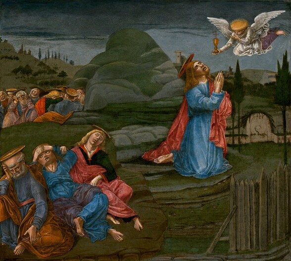 A young bearded man, Jesus, kneels and looks up at a winged angel as two groups of sleeping men huddle behind him in this almost square painting. The men all have pale skin, blond or white hair, and gold, disk-like halos. Jesus’s halo has a red cross on it as well, and it hovers over his long copper-colored hair. He wears a terracotta-red cloak over a celestial-blue robe, and he presses his hands together in prayer as he looks sharply up at the winged angel floating in the upper right corner of the composition. Smaller in scale, the angel has white wings and flowing robes, and holds a gold chalice in one outstretched hand. The angel’s head is surrounded by a flat, golden glow like a cap. The men behind Jesus, to our left, sleep in two groups in the gloomy, rocky landscape. The men wear robes in rose pink, black, scarlet red, steel blue, or brown. Closest to us are three men who lie close behind Jesus’s bare feet, while a larger group is tucked beyond a mound in the near distance. The terrain is painted with muted green, gray, and tan with a fence in the lower left corner and a rock formation rising in the middle of the landscape. Distant hills studded with trees and a few structures span the high horizon, which comes three-quarters of the way up the composition. A thick band of charcoal-gray clouds descends on the slate-blue sky above.
